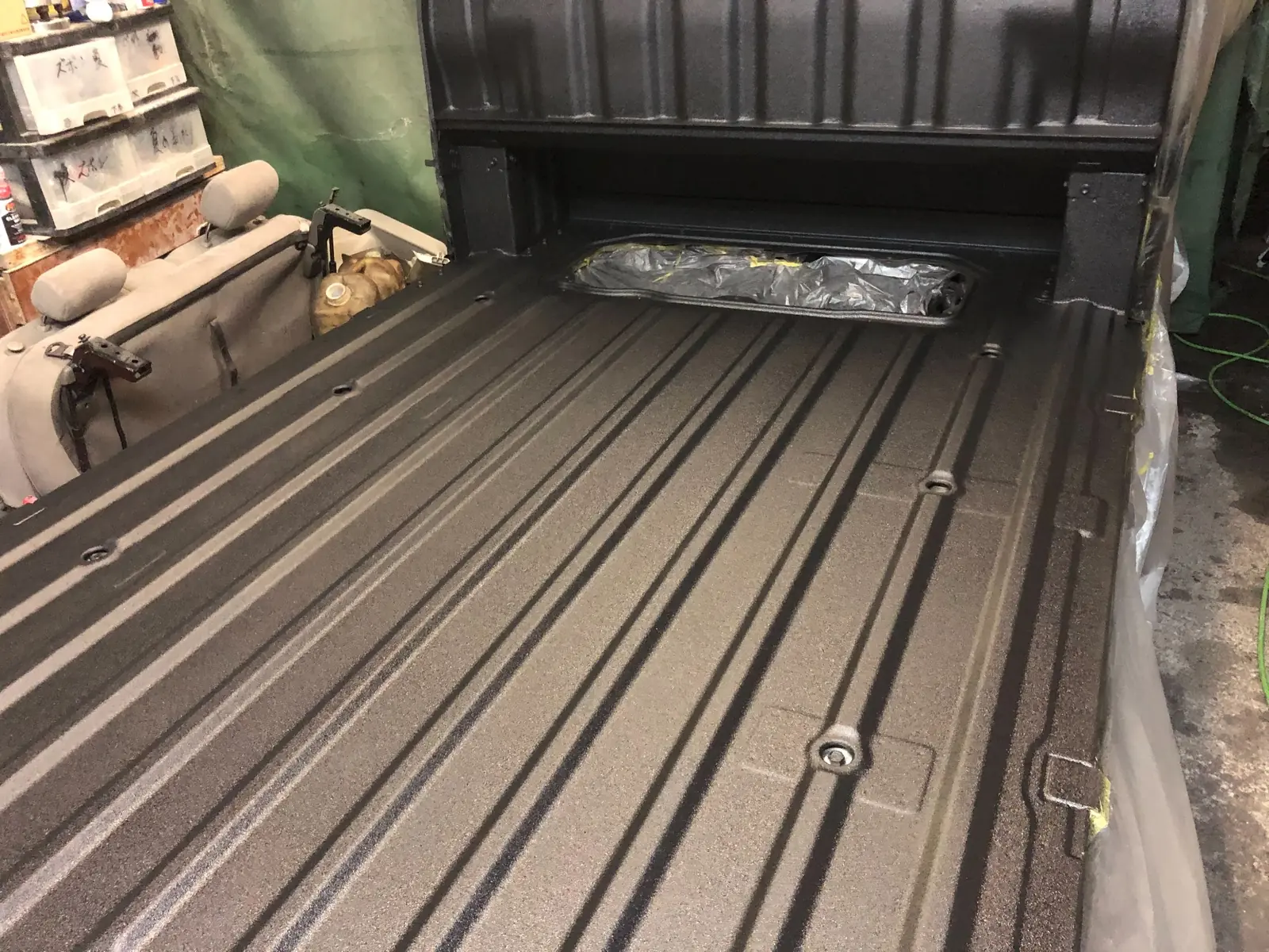 Angled view of the Hijet Jumbo cargo bed with black RAPTOR coating