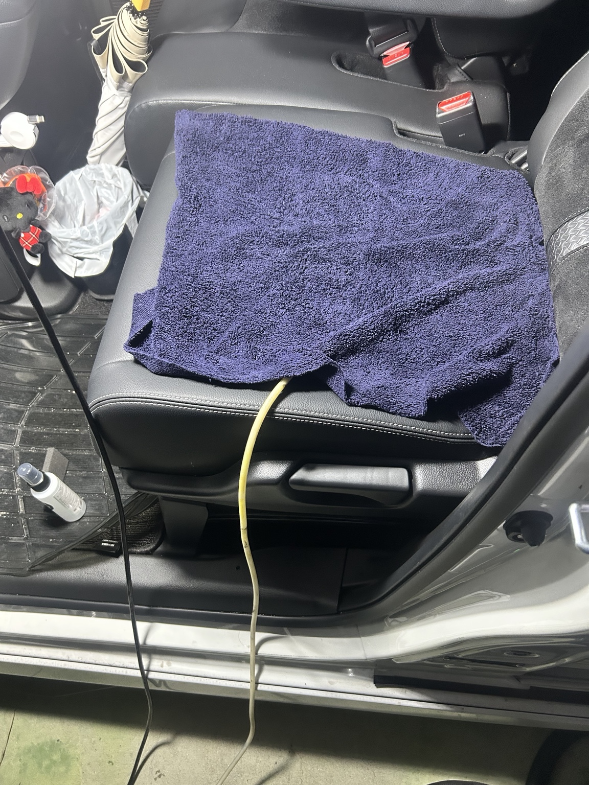 Close-up of the damp towel covering the N-BOX passenger seat